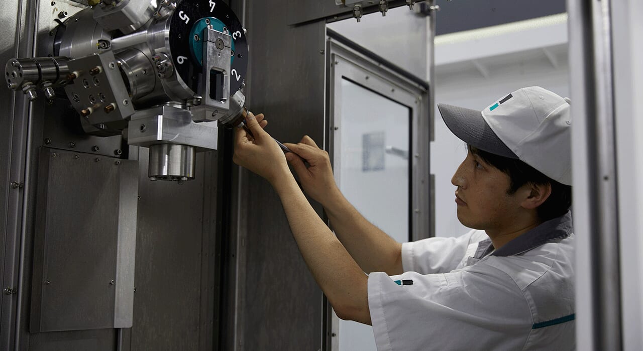 An automotive engine part shown inside Sugino's Jet Clean Center high pressure water jet deburring and part cleaning machine